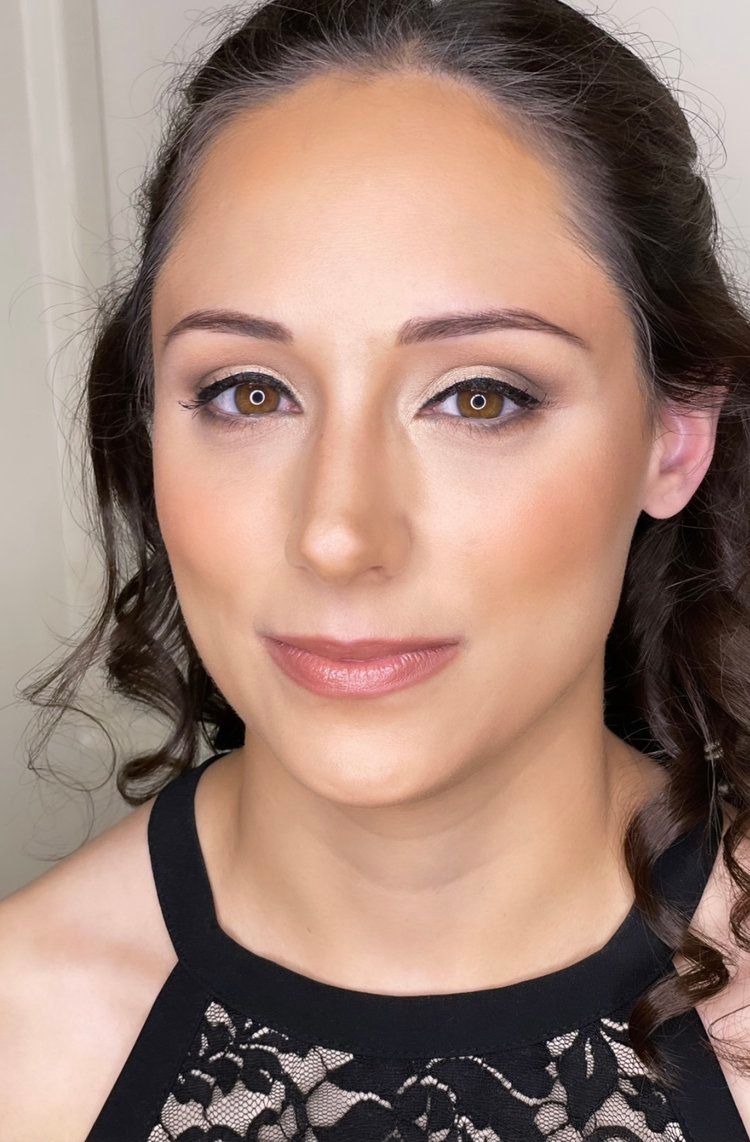 A close up of a woman 's face with makeup on.