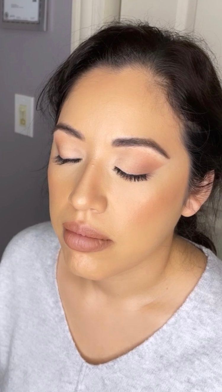 A close up of a woman 's face with her eyes closed.