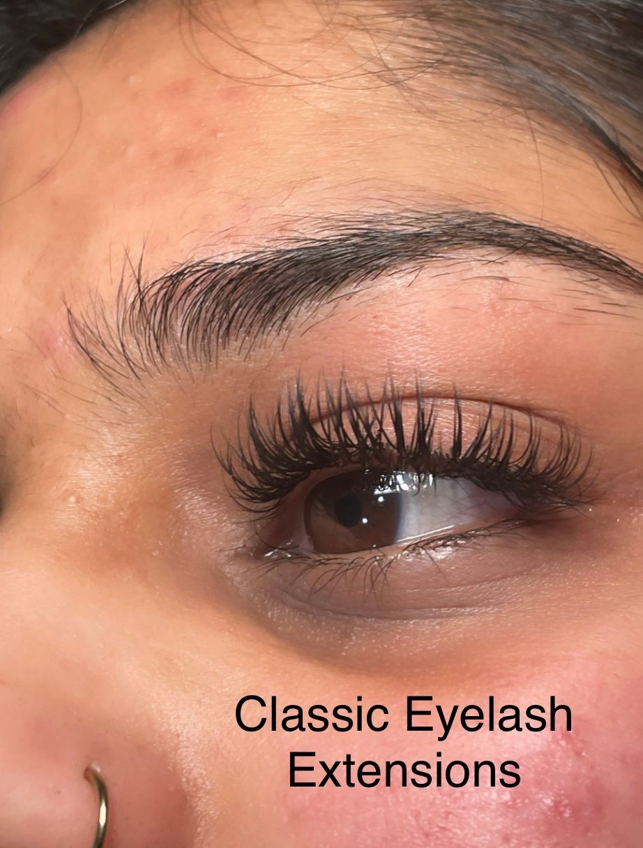 A close up of a woman 's eye with classic eyelash extensions.
