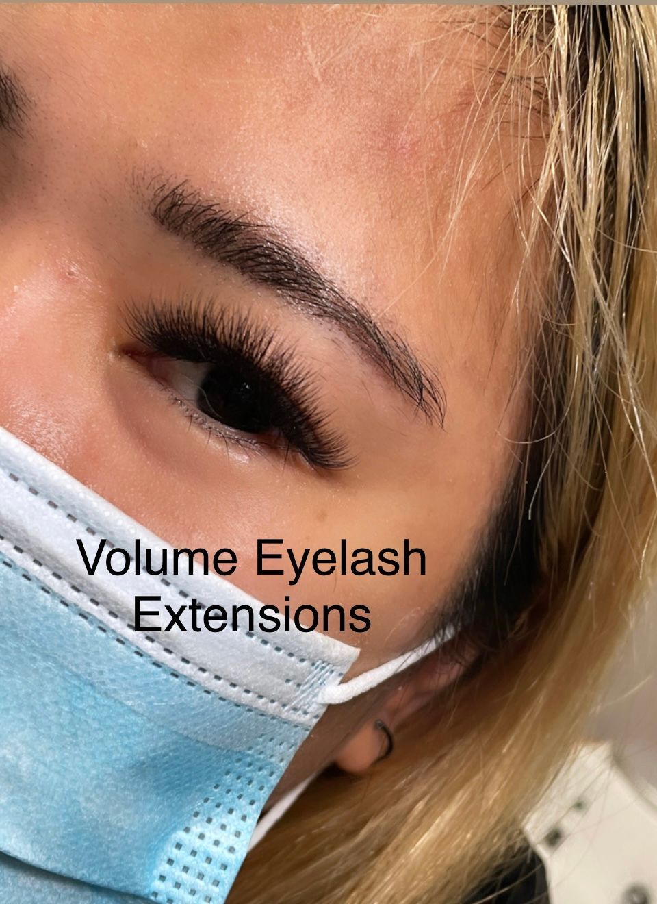 A close up of a woman wearing a mask with eyelash extensions.