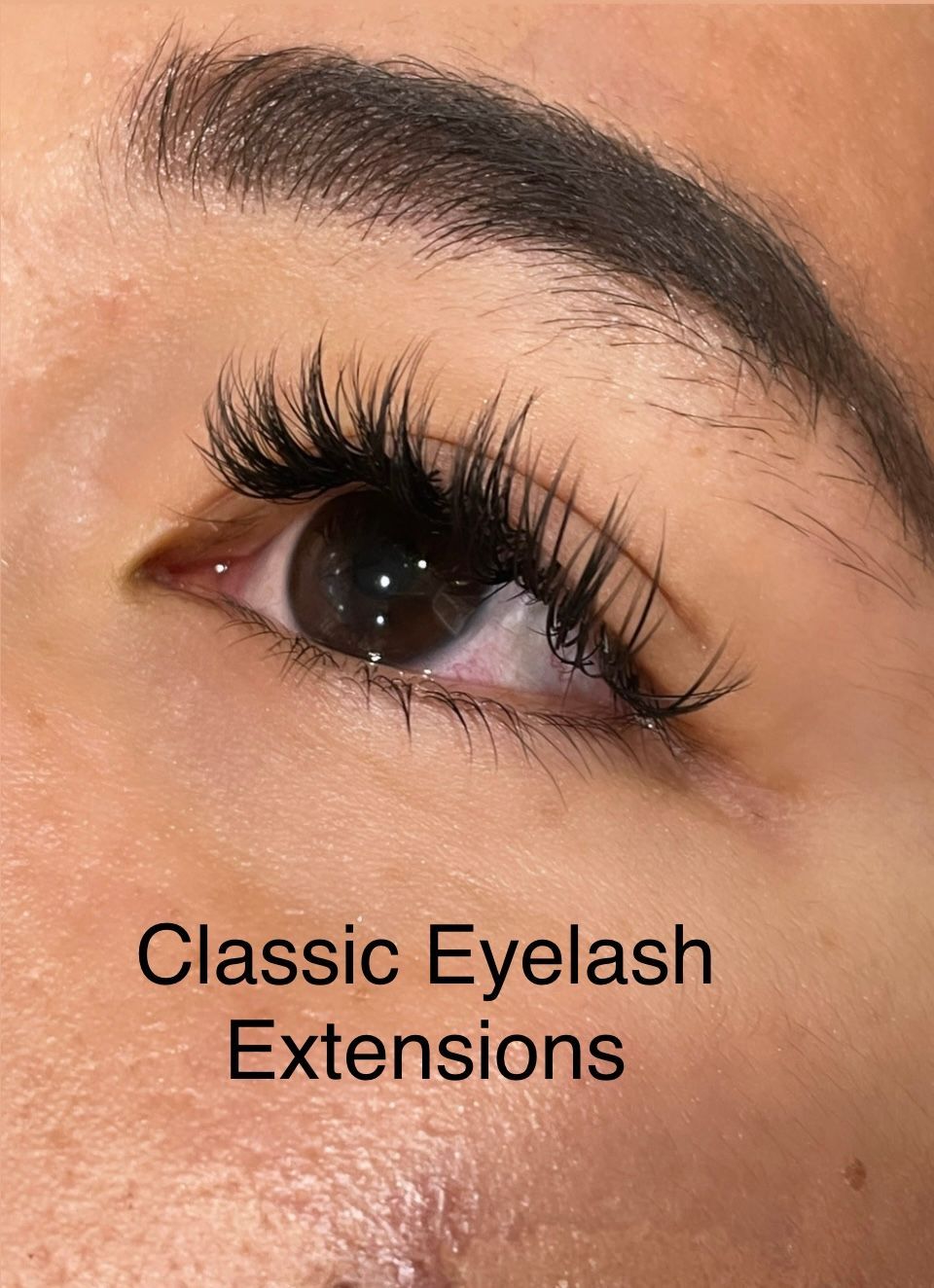A close up of a woman 's eye with classic eyelash extensions.