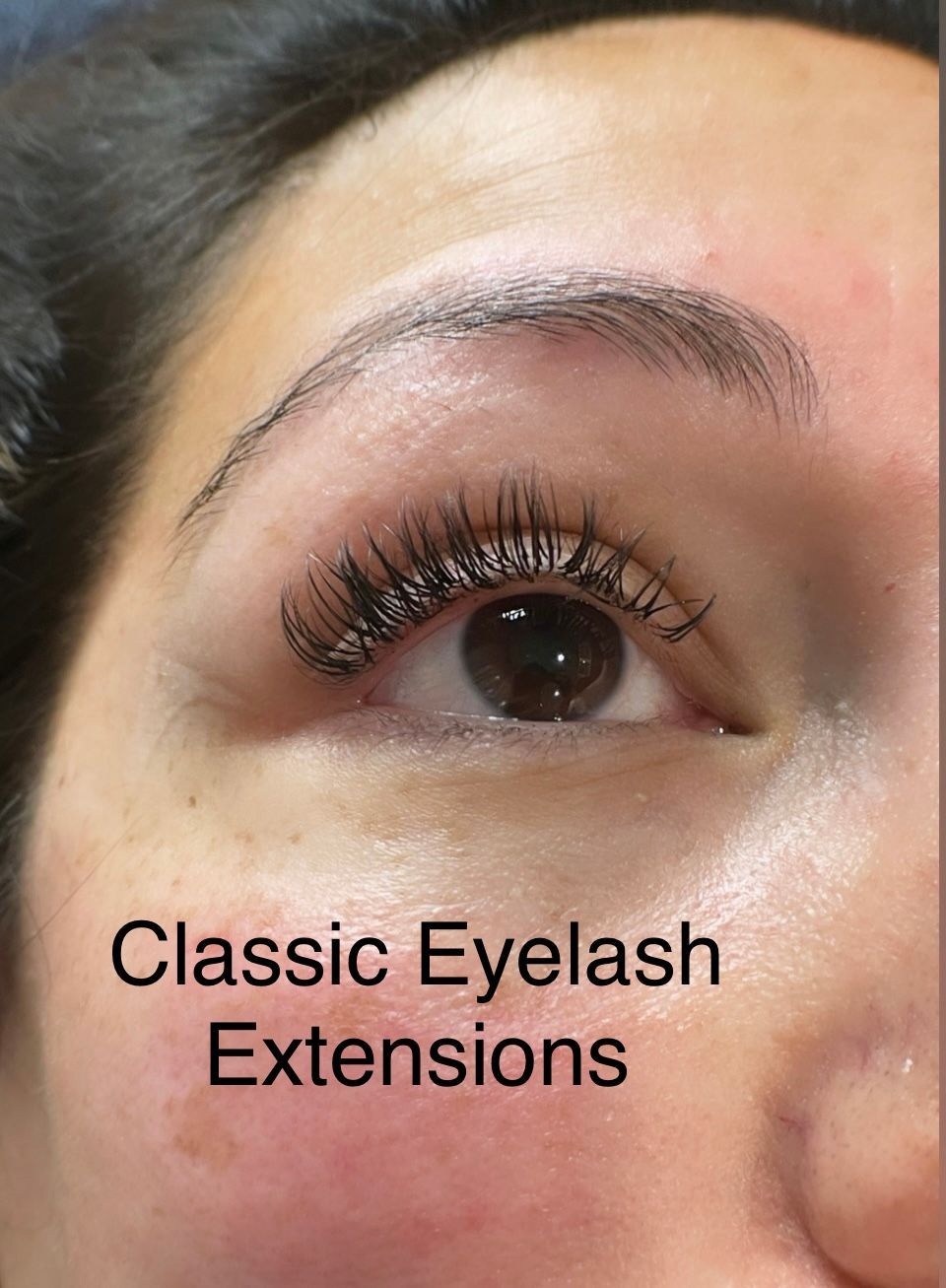 A close up of a woman 's eye with classic eyelash extensions