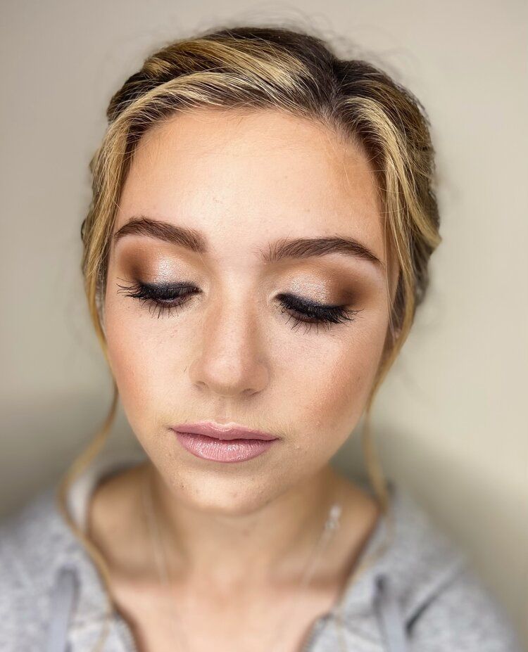 A close up of a woman 's face with makeup on.