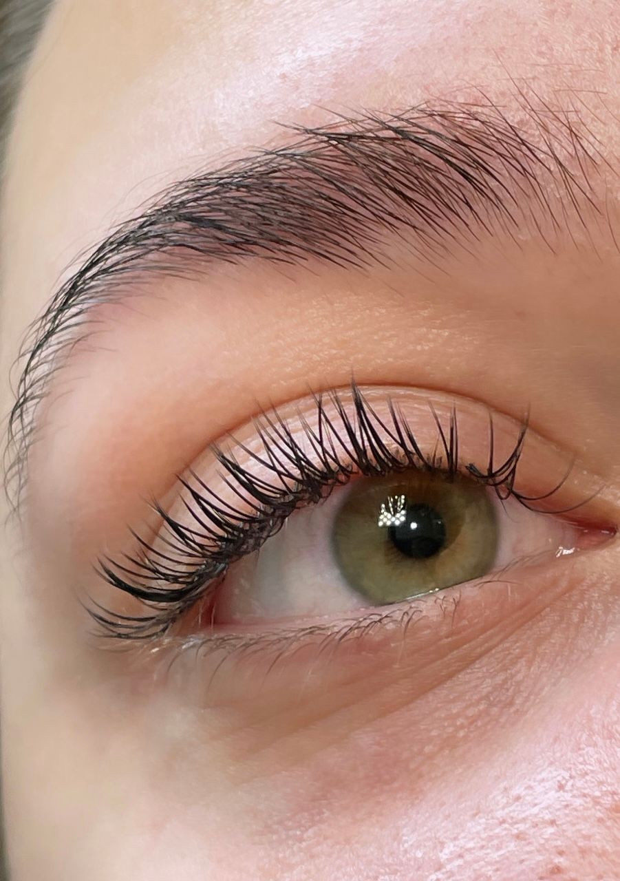 A close up of a woman 's eye with long eyelashes.