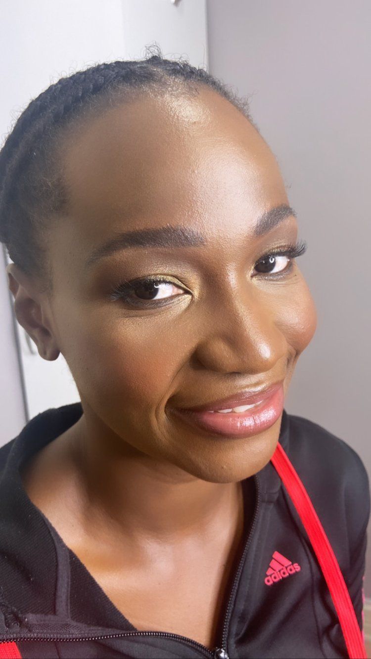 A close up of a woman wearing a black adidas jacket