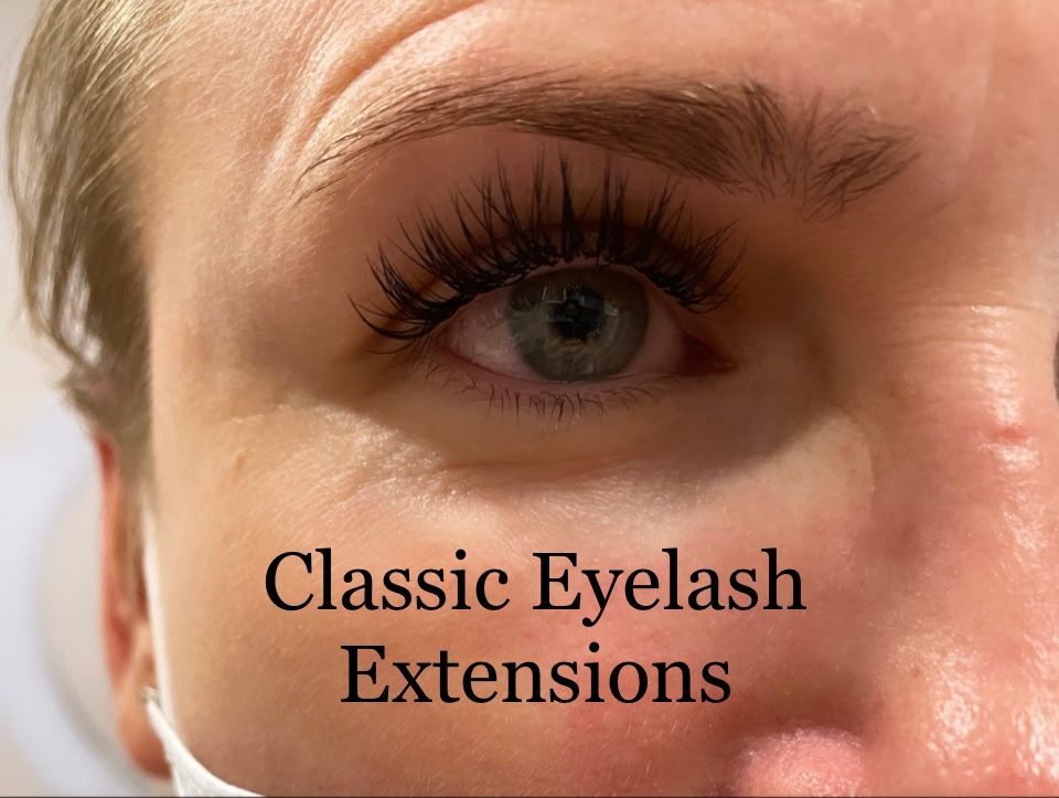 A close up of a woman 's eye with classic eyelash extensions.