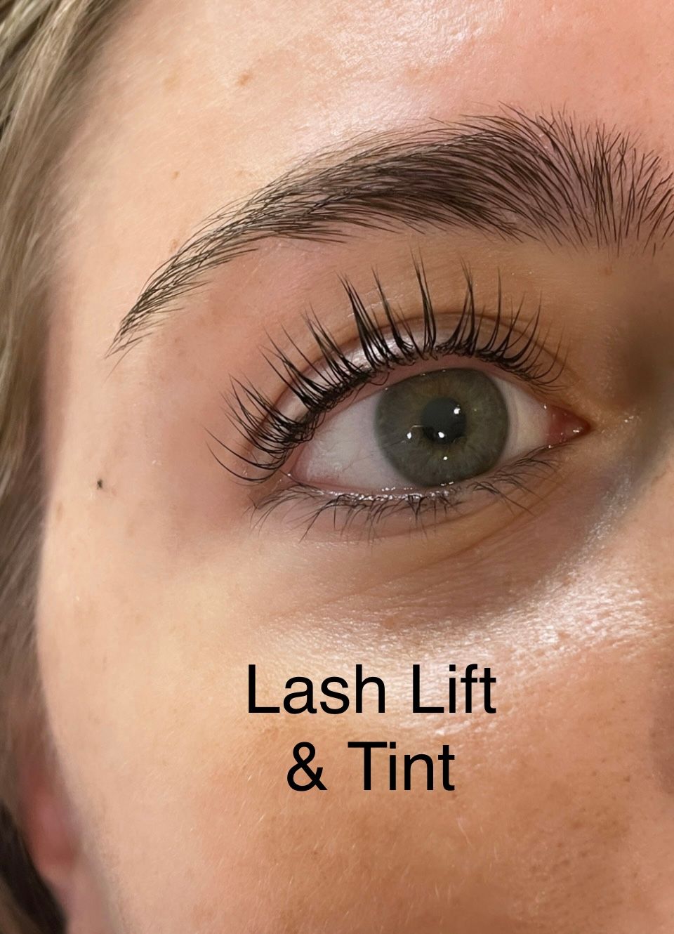 A close up of a woman 's eye with lash lift and tint.