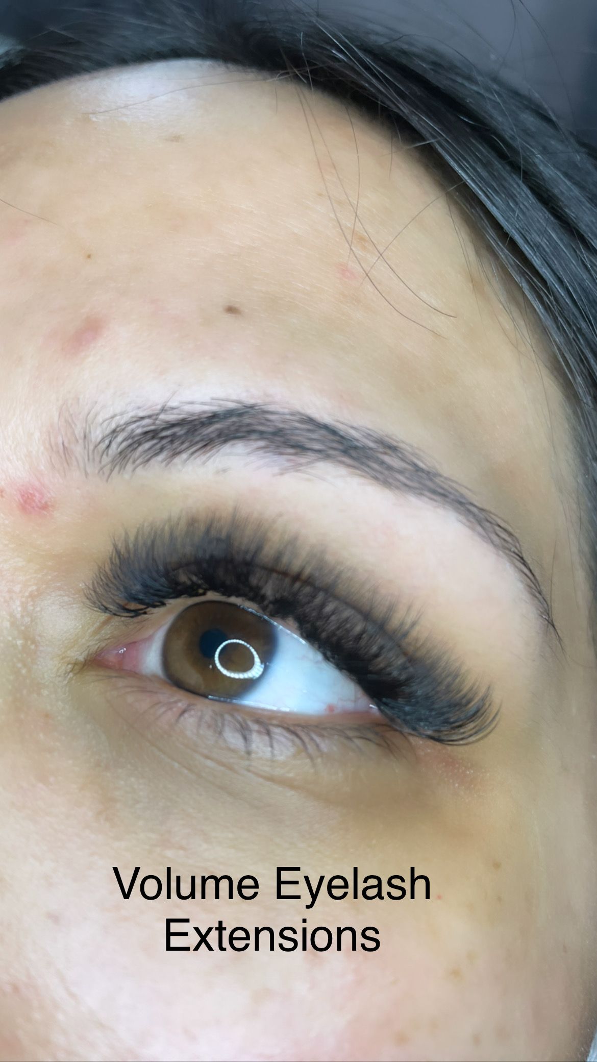 A close up of a woman 's eye with volume eyelash extensions.