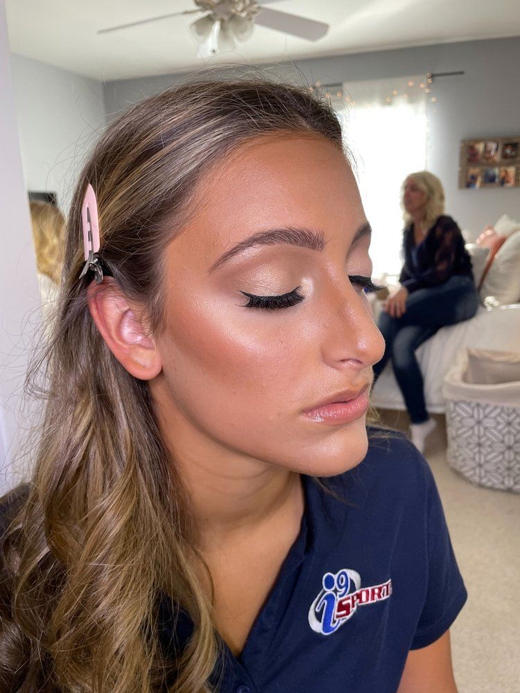 A woman is wearing a blue shirt with the word spies on it.