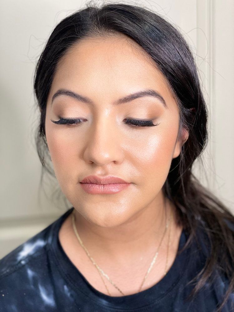 A close up of a woman 's face with her eyes closed.