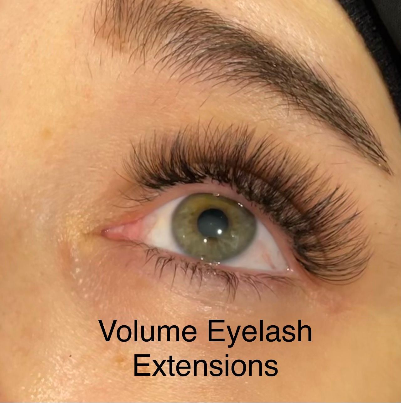 A close up of a woman 's eye with volume eyelash extensions