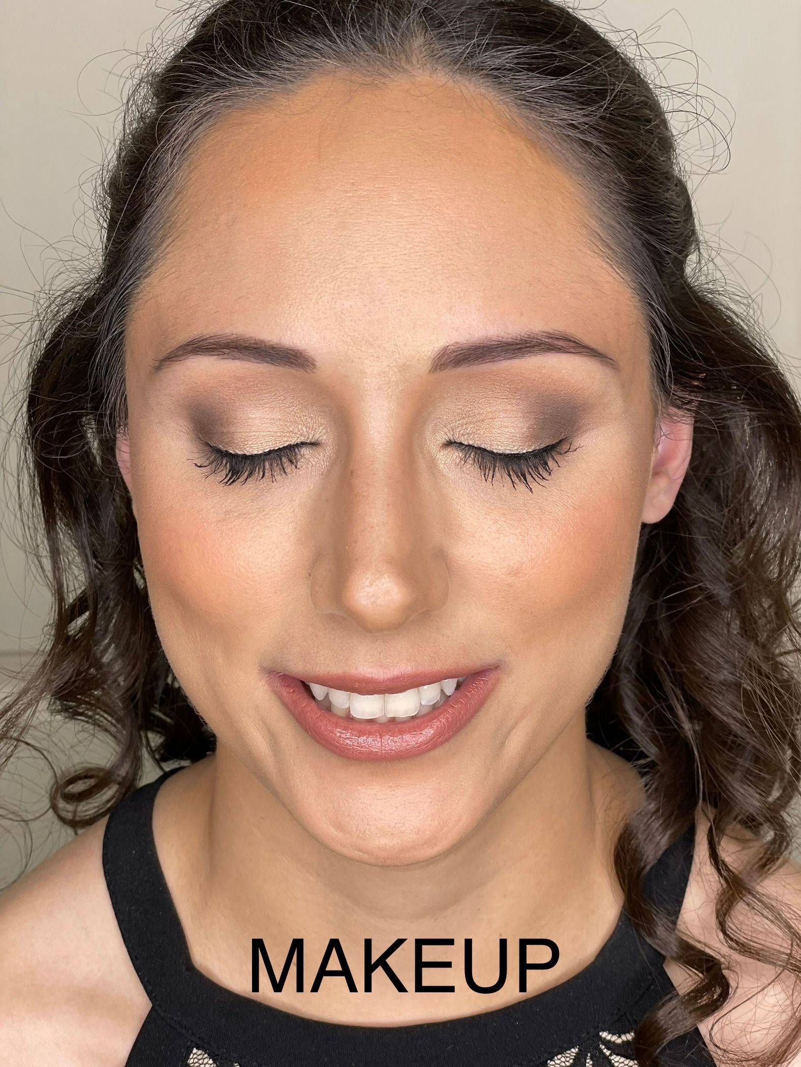A close up of a woman 's face with the word makeup on it.