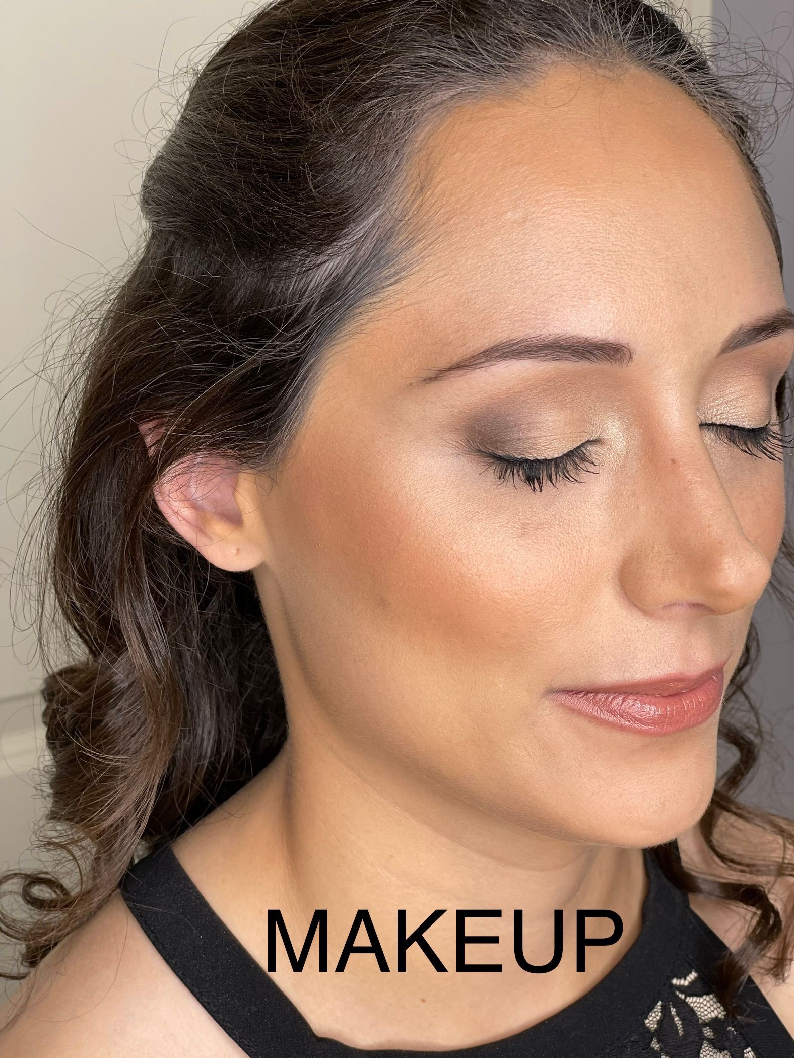 A close up of a woman 's face with makeup on.