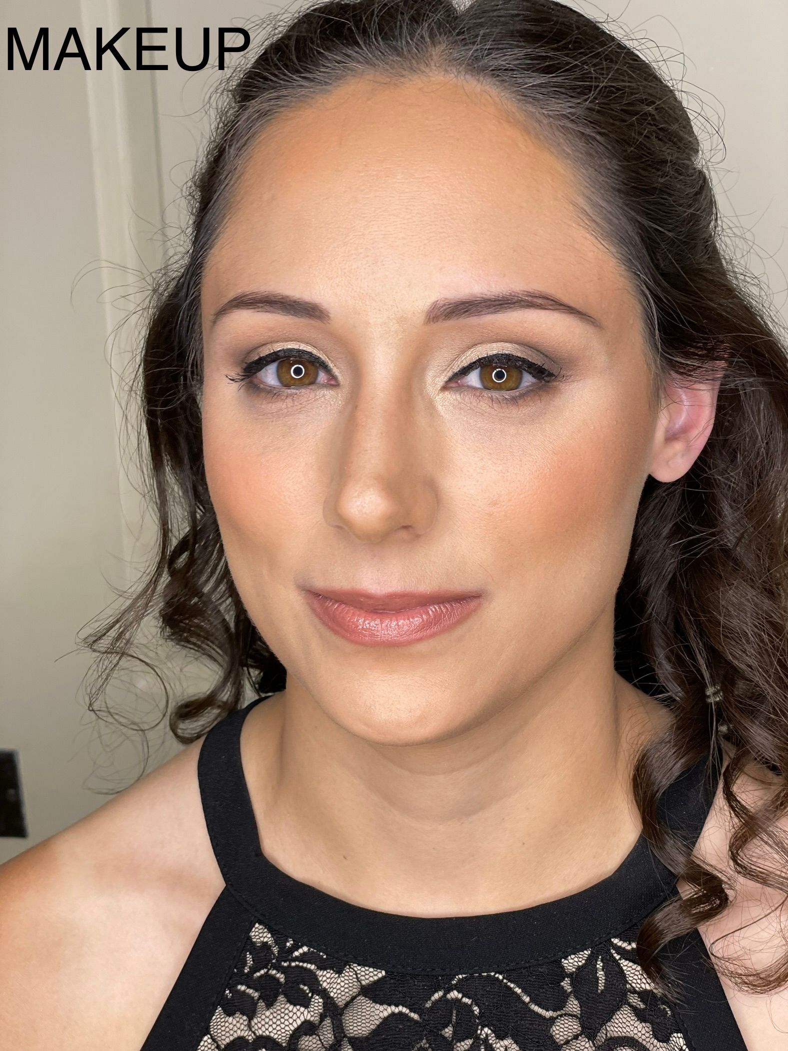 A close up of a woman 's face with makeup on.