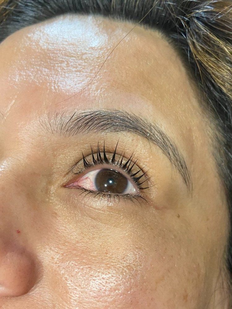 A close up of a woman 's eye with mascara on it.