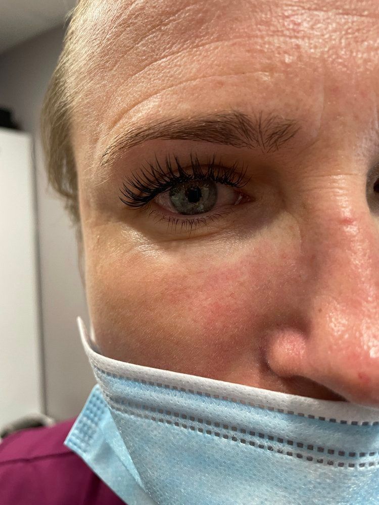 A close up of a woman wearing a face mask.