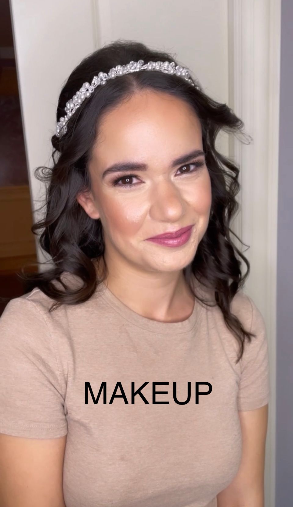 A woman wearing a headband and a t-shirt that says makeup
