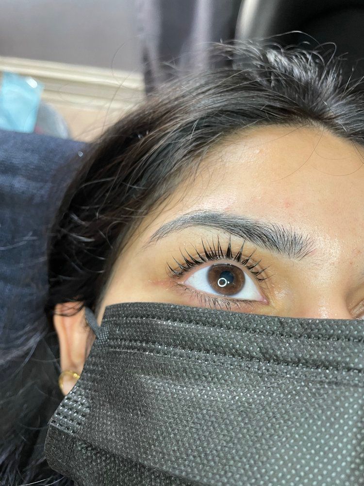 A close up of a woman wearing a mask and mascara.