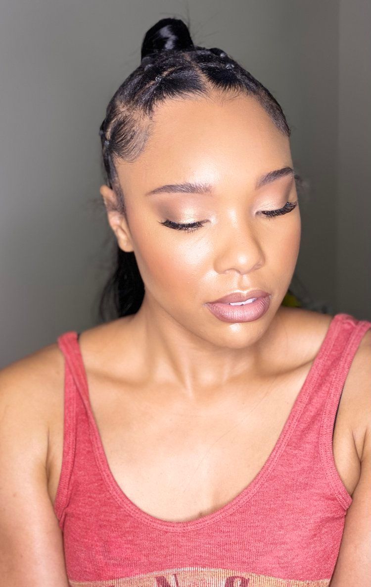 The woman is wearing a red tank top and has her eyes closed.