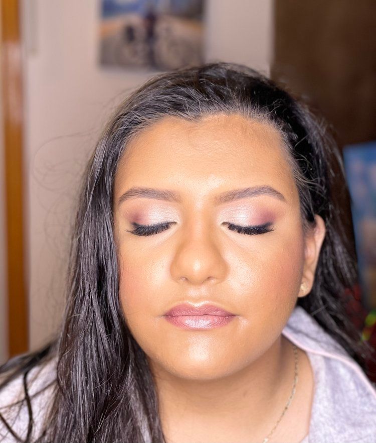 A close up of a woman 's face with her eyes closed.