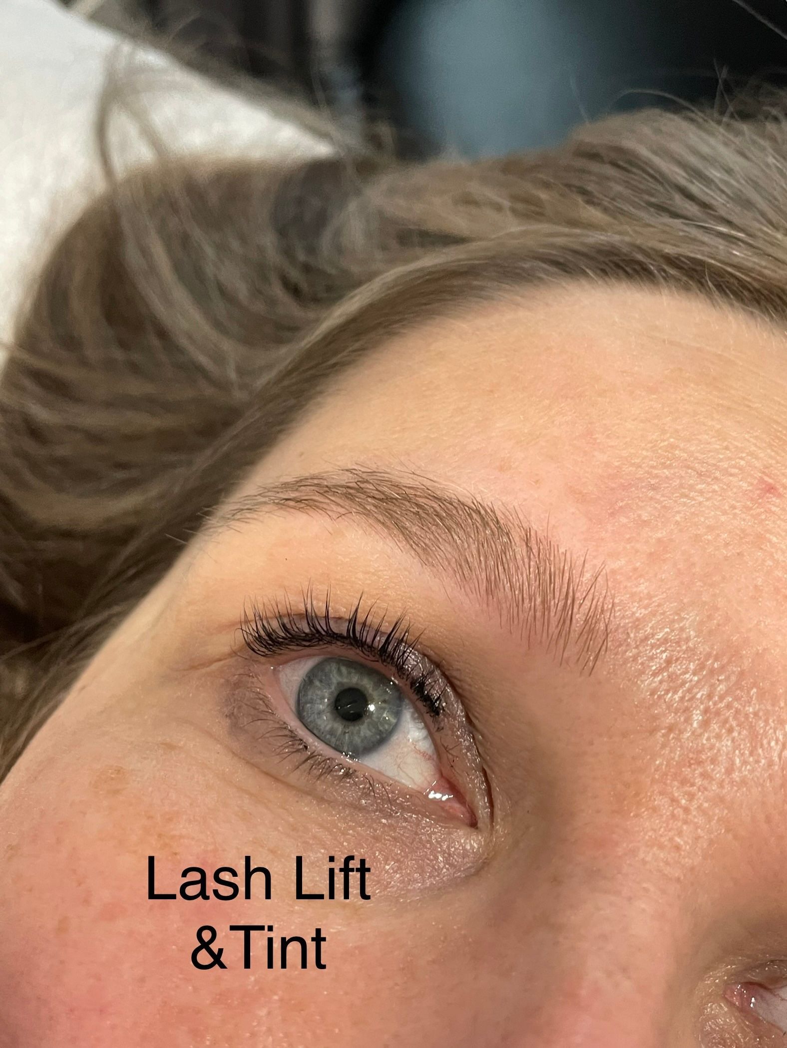 A close up of a woman 's eye with lash lift and tint.