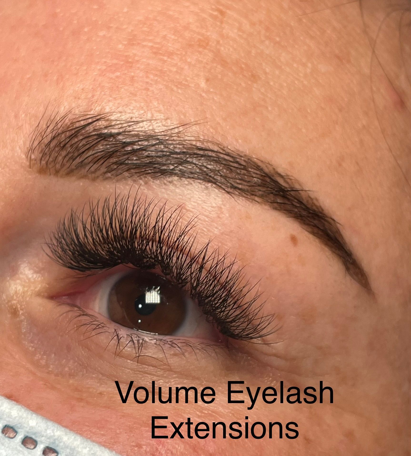 A close up of a woman 's eye with volume eyelash extensions.