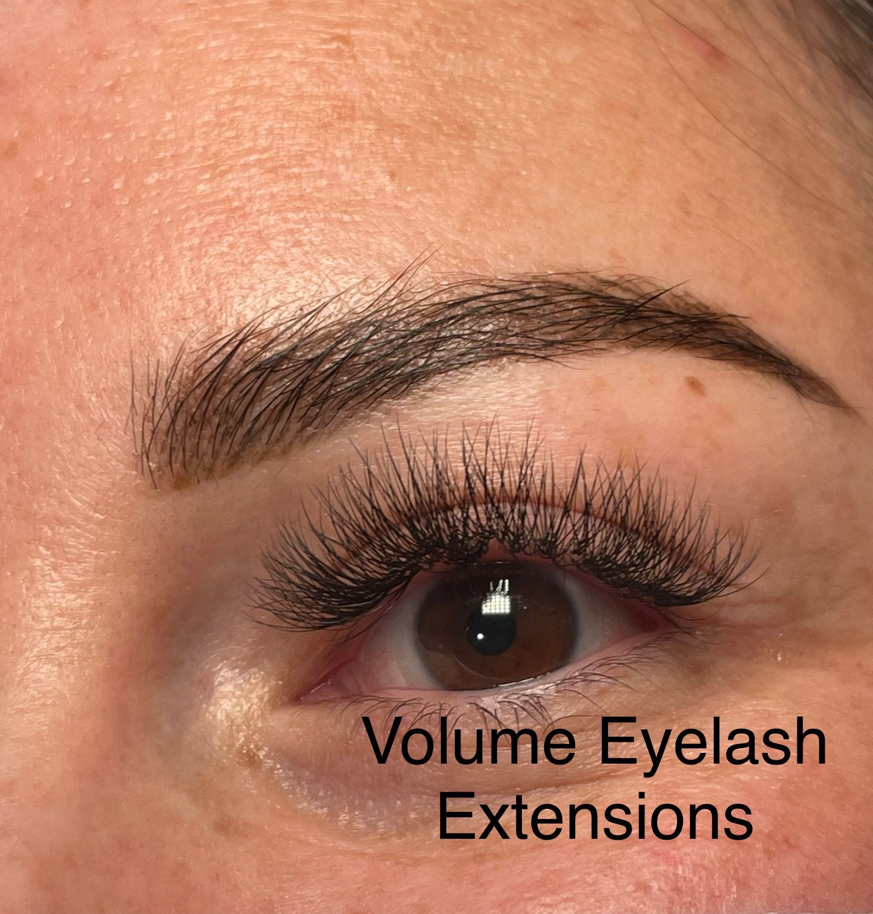 A close up of a woman 's eye with volume eyelash extensions