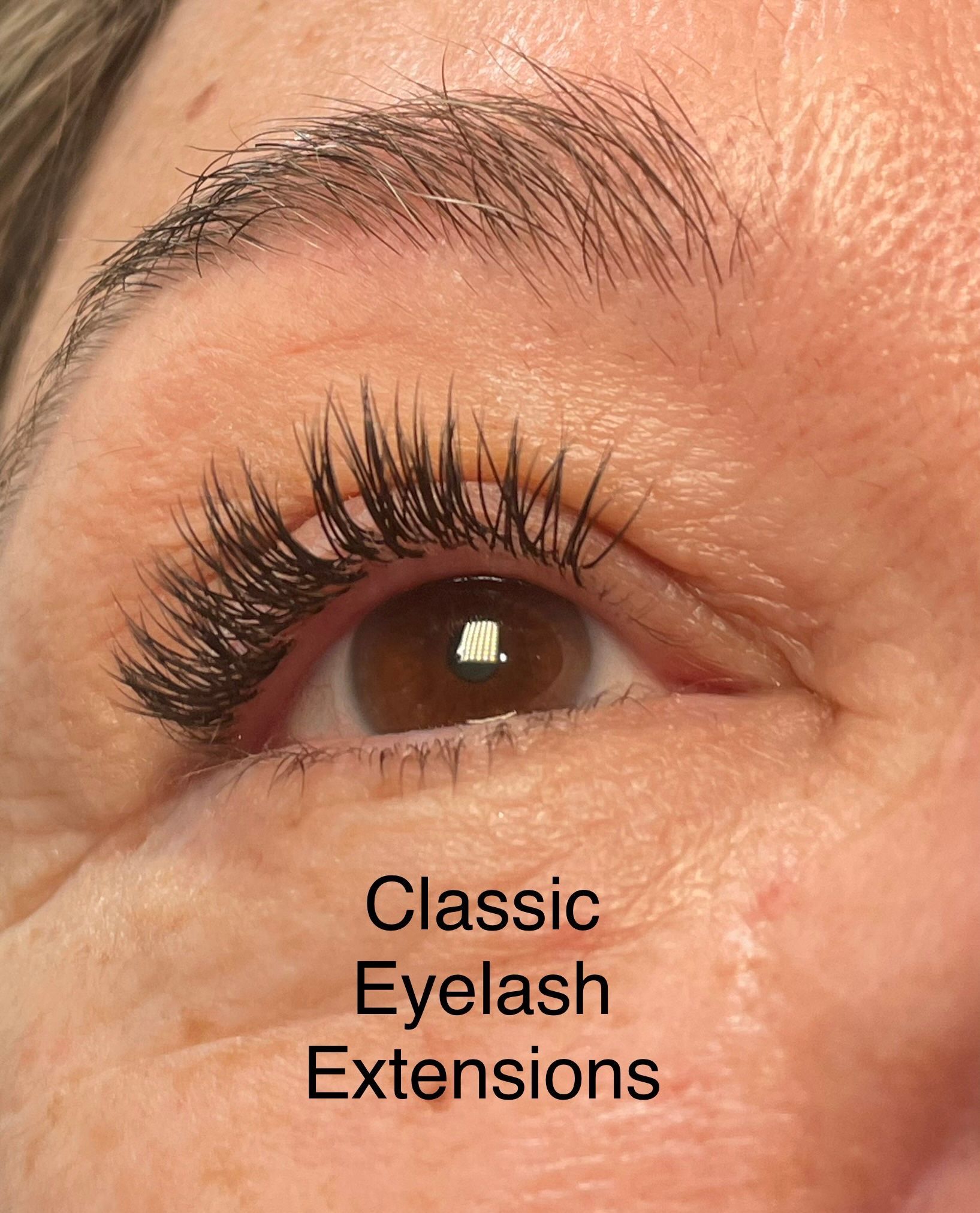 A close up of a woman 's eye with classic eyelash extensions