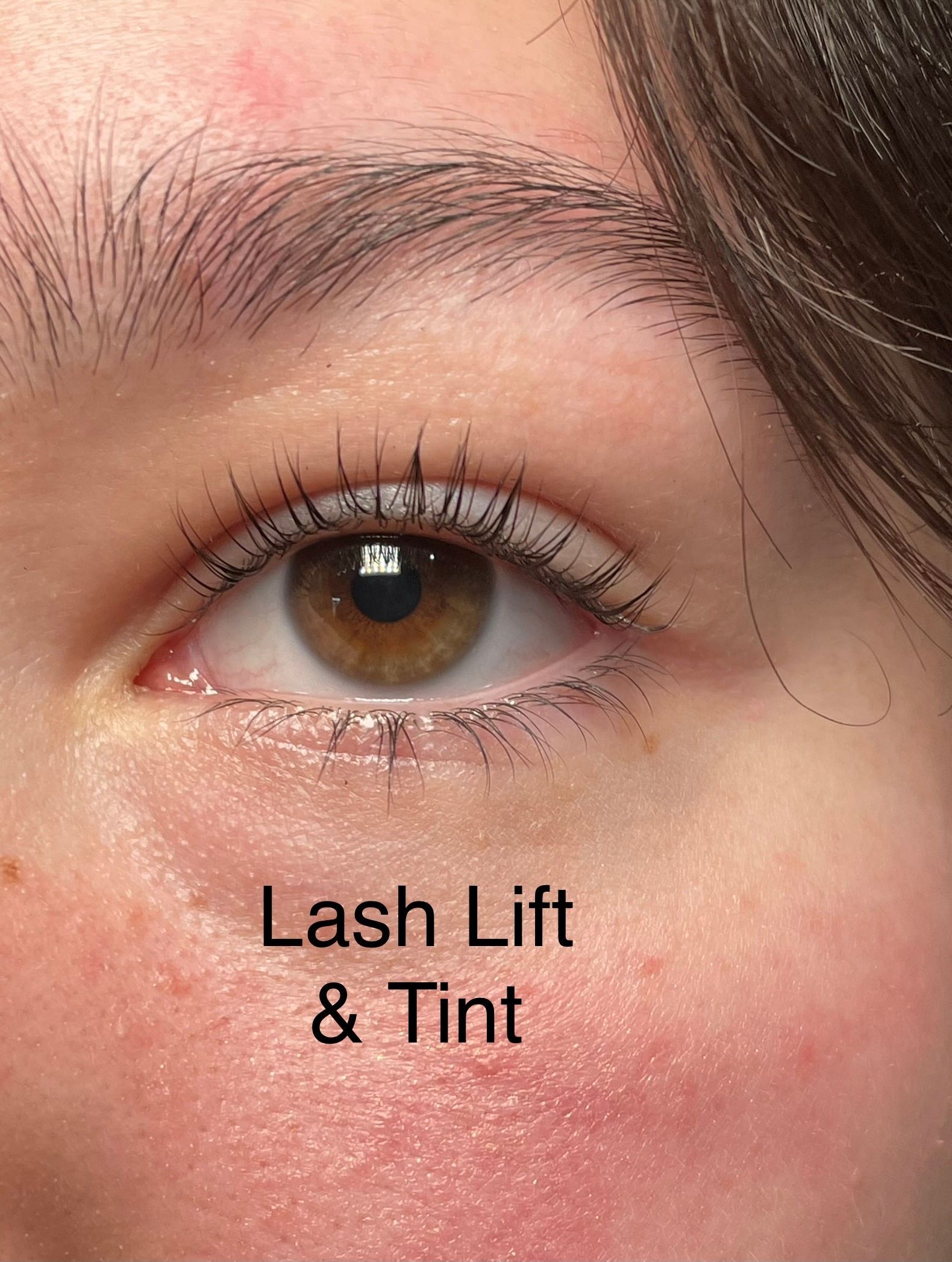 A close up of a woman 's eye with lash lift and tint.