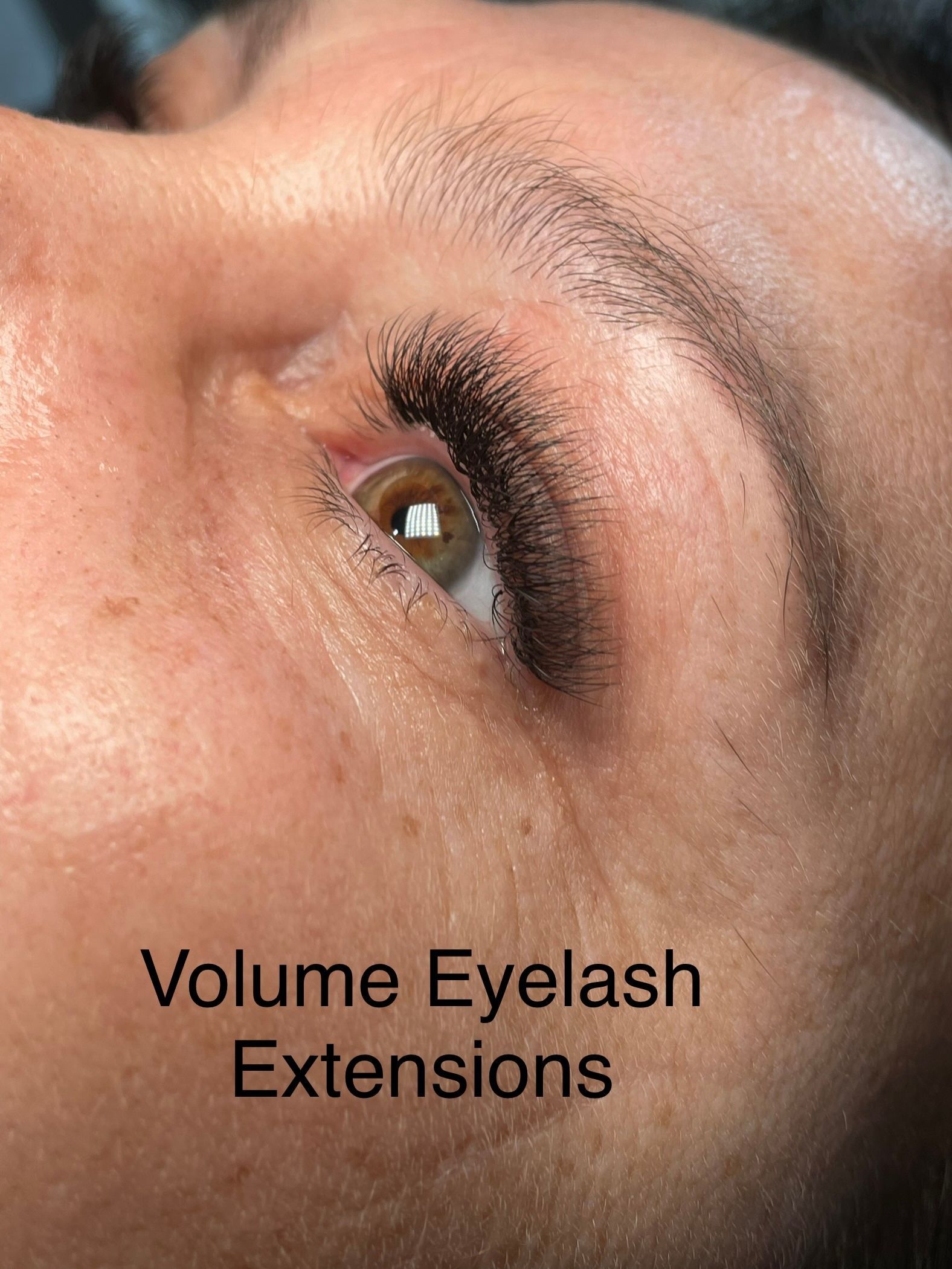 A close up of a woman 's eye with volume eyelash extensions.