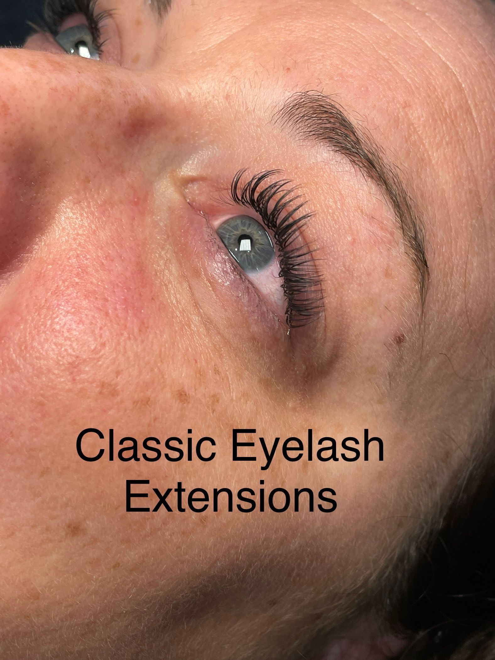 A close up of a woman 's face with classic eyelash extensions.