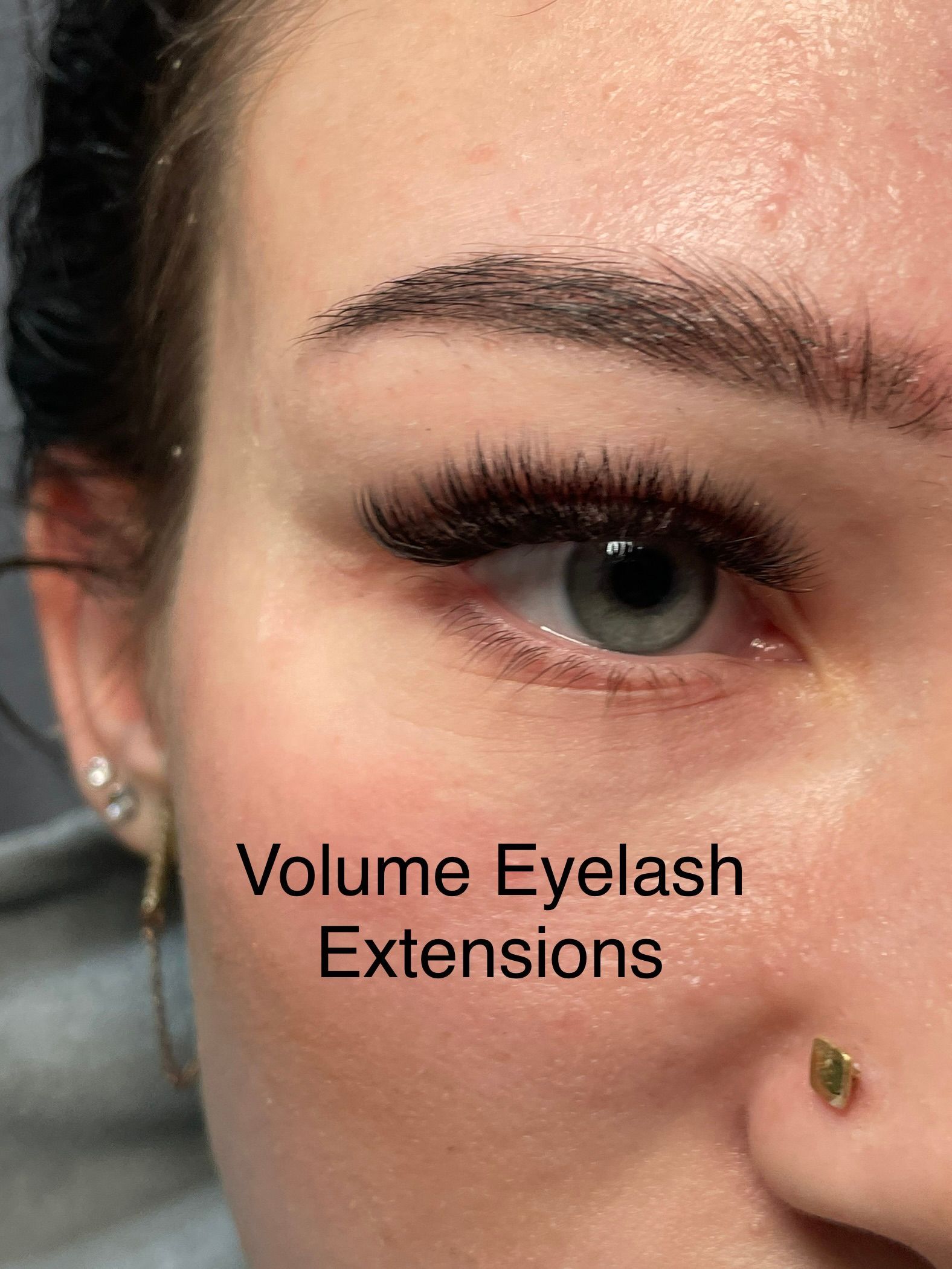 A close up of a woman 's eye with volume eyelash extensions.
