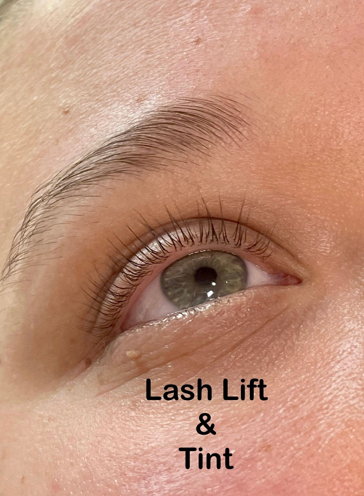 A close up of a woman 's eye with lash lift and tint.
