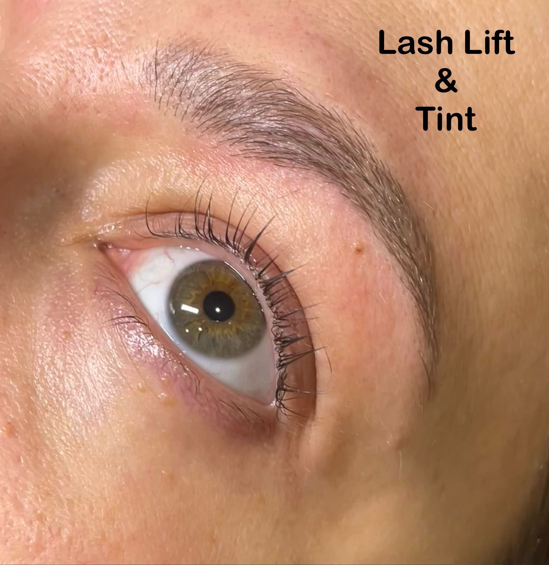 A close up of a woman 's eye with lash lift and tint