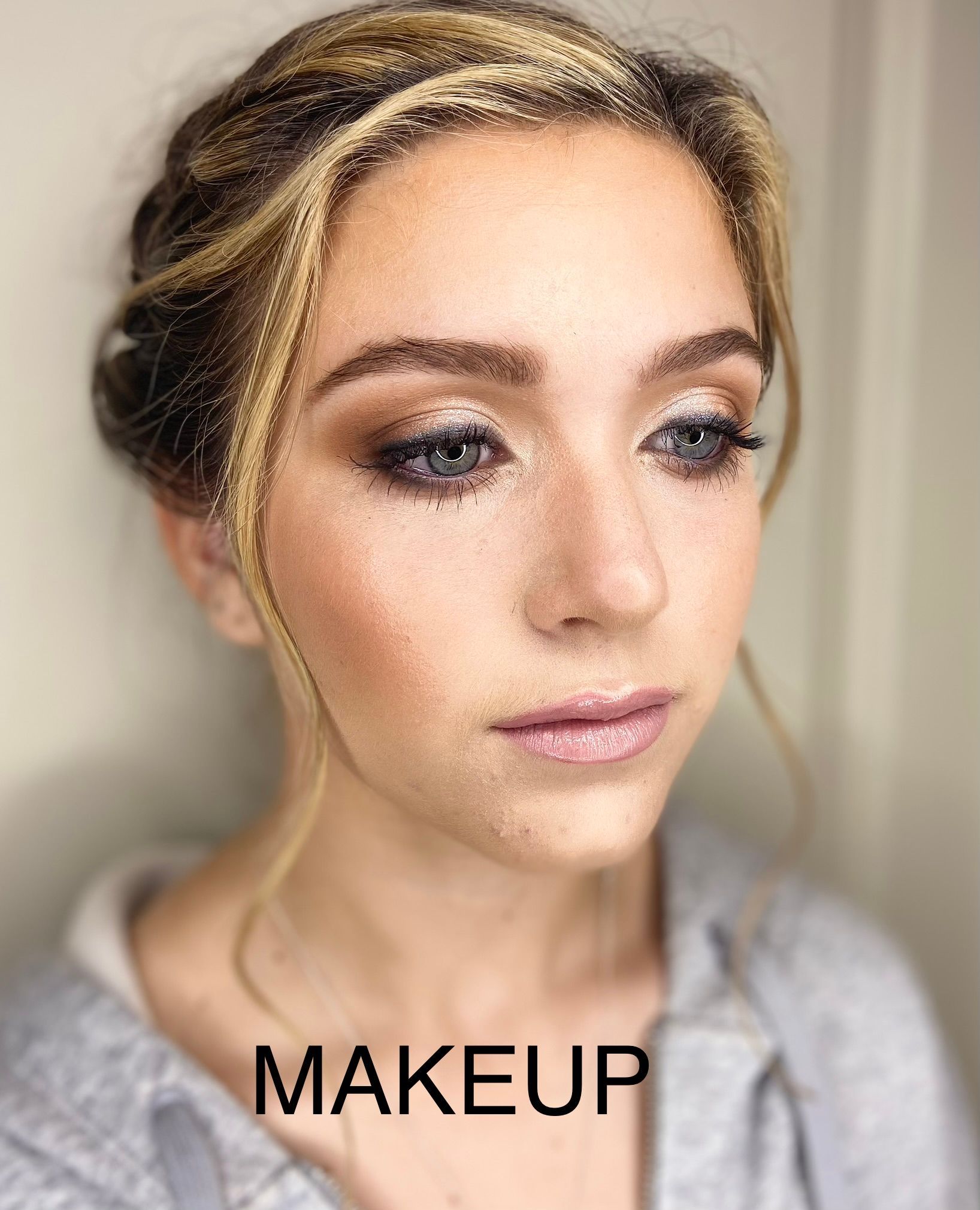 A close up of a woman 's face with makeup on.