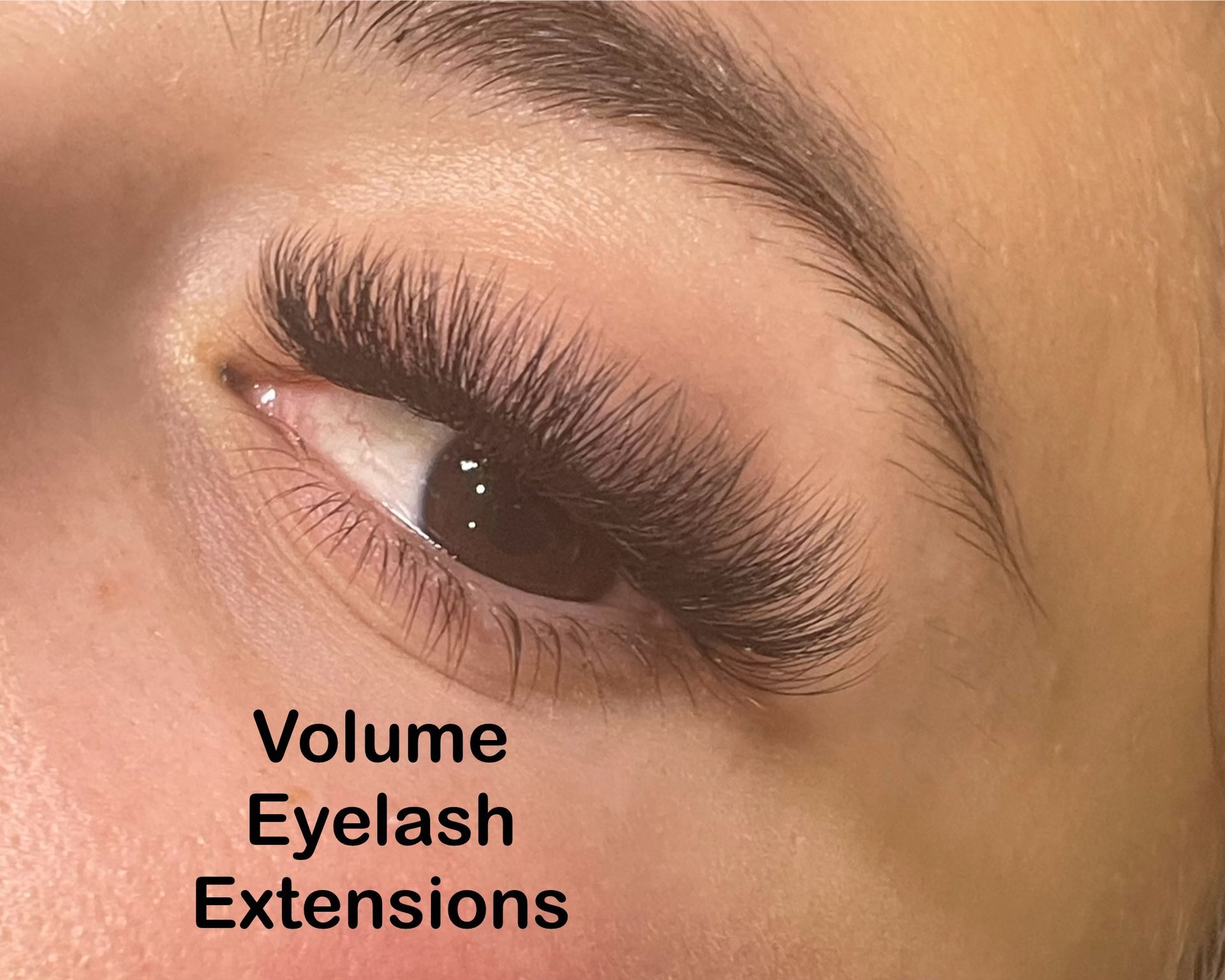 A close up of a woman 's eye with volume eyelash extensions.