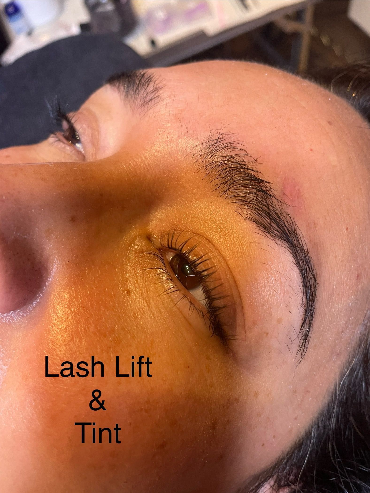 A close up of a woman 's face with a lash lift and tint.