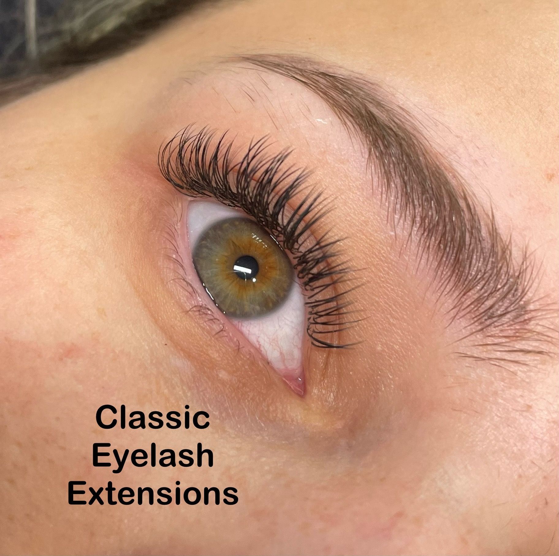 A close up of a woman 's eye with classic eyelash extensions