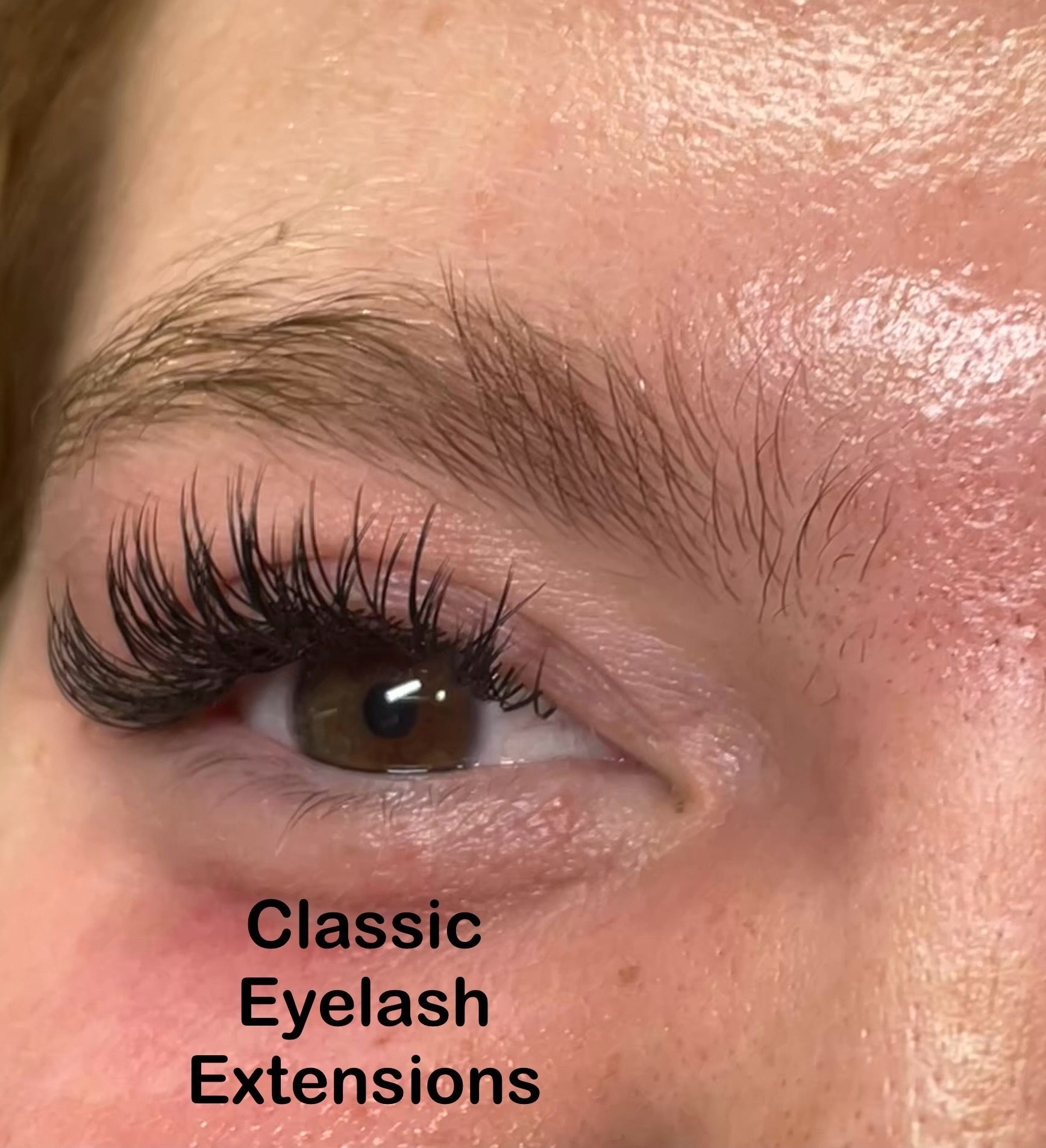 A close up of a woman 's eye with classic eyelash extensions.