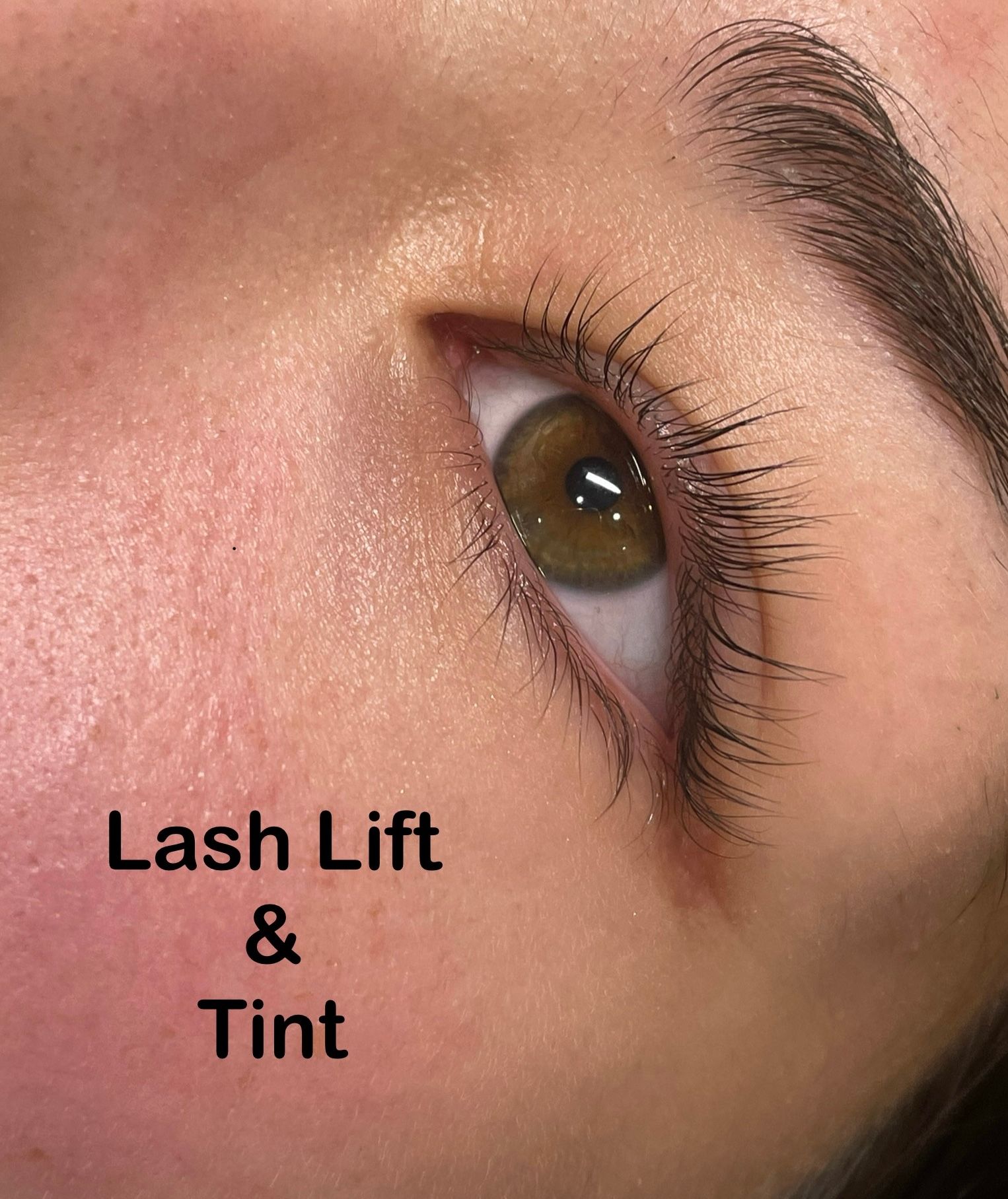 A close up of a woman 's eye with lash lift and tint