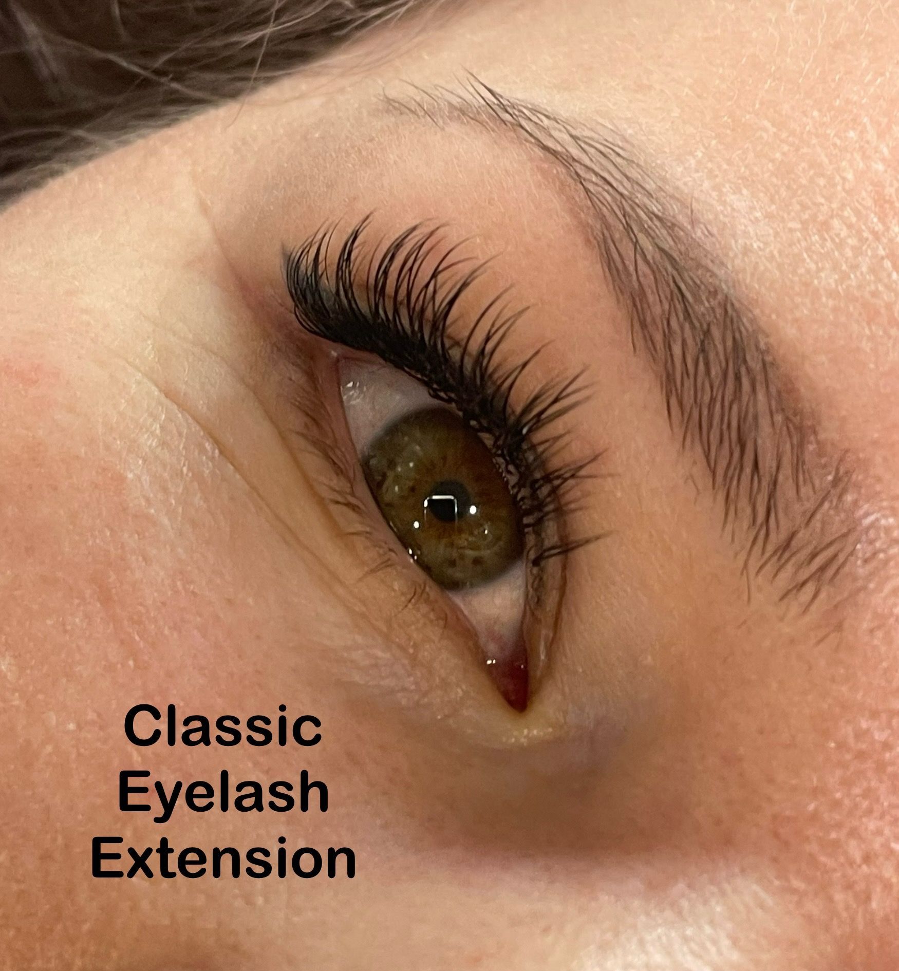 A close up of a woman 's eye with classic eyelash extension
