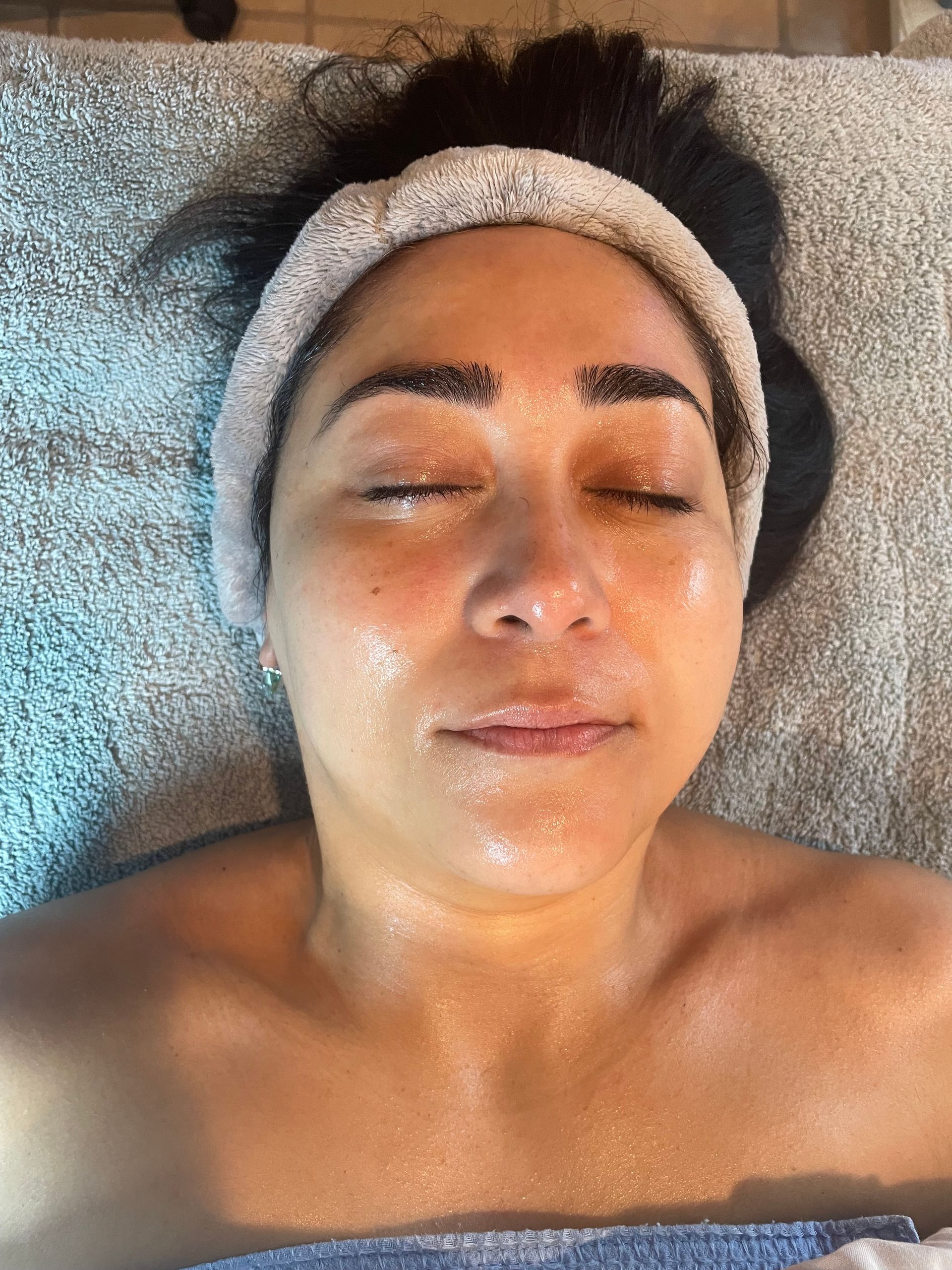 A woman is laying on a bed with a headband on her head.