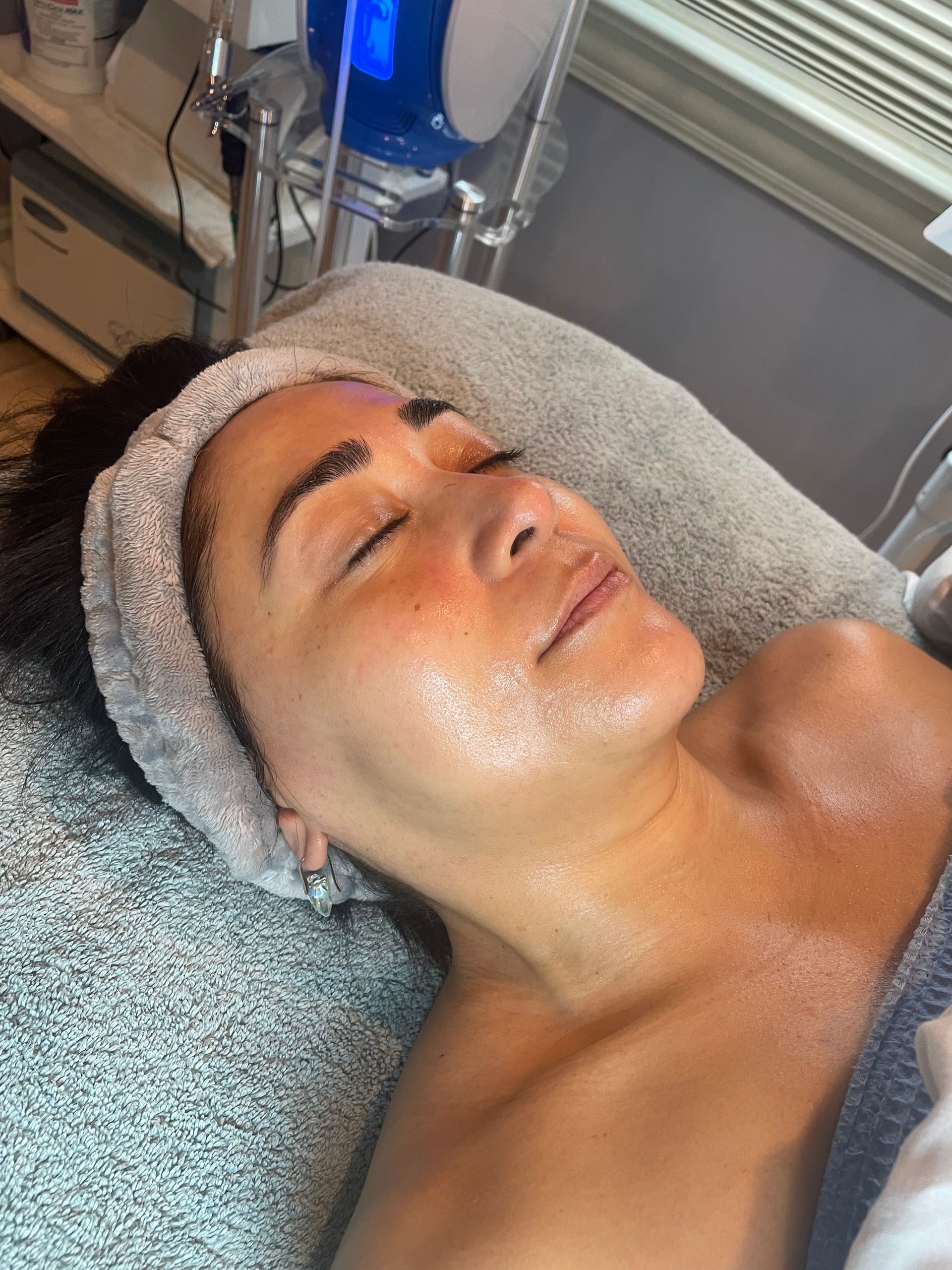 A woman is laying on a bed with a headband on her head.