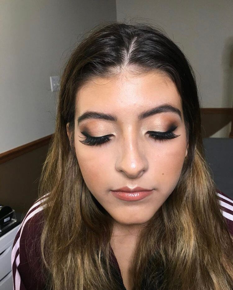 A close up of a woman 's face with makeup on.