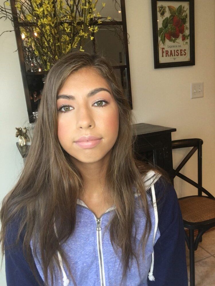 A woman is standing in front of a framed picture that says fraises
