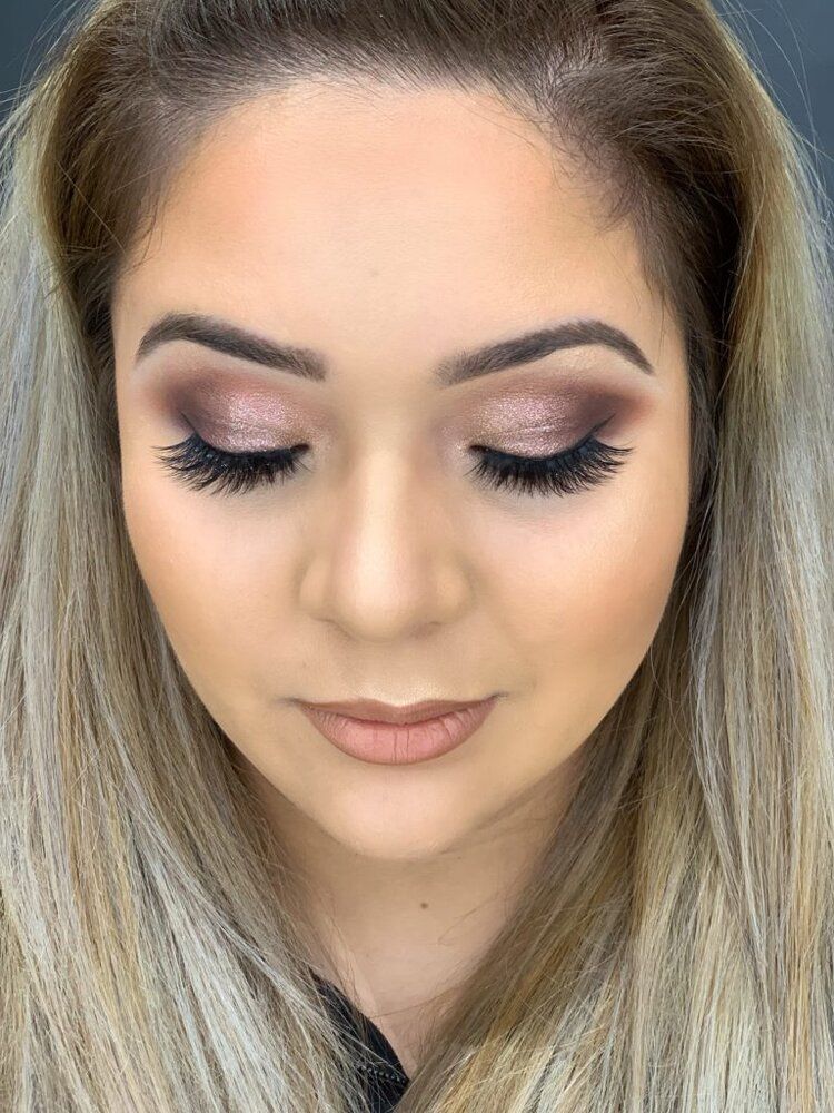 A close up of a woman 's face with makeup on.