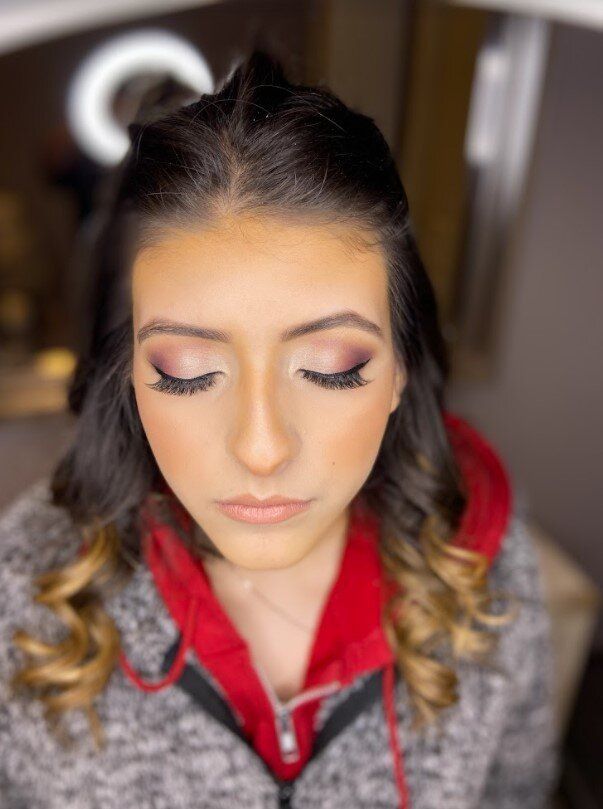 A close up of a woman 's face with her eyes closed.