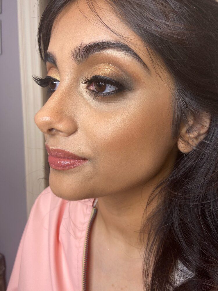 A close up of a woman 's face with makeup on.