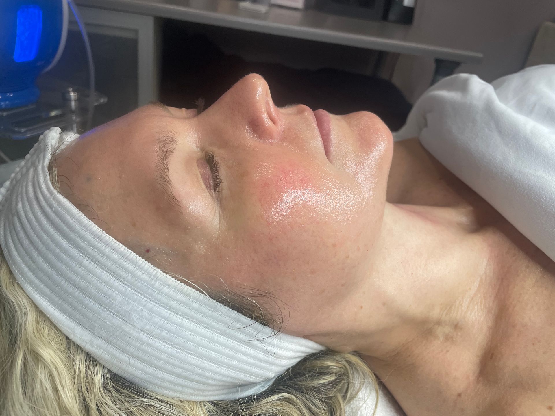 A woman is laying on a bed with a headband on her head.