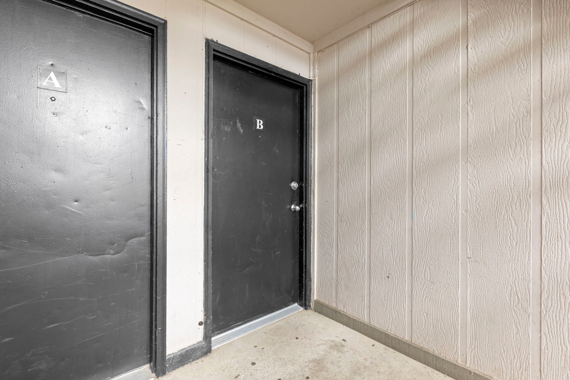 Two black doors labeled
